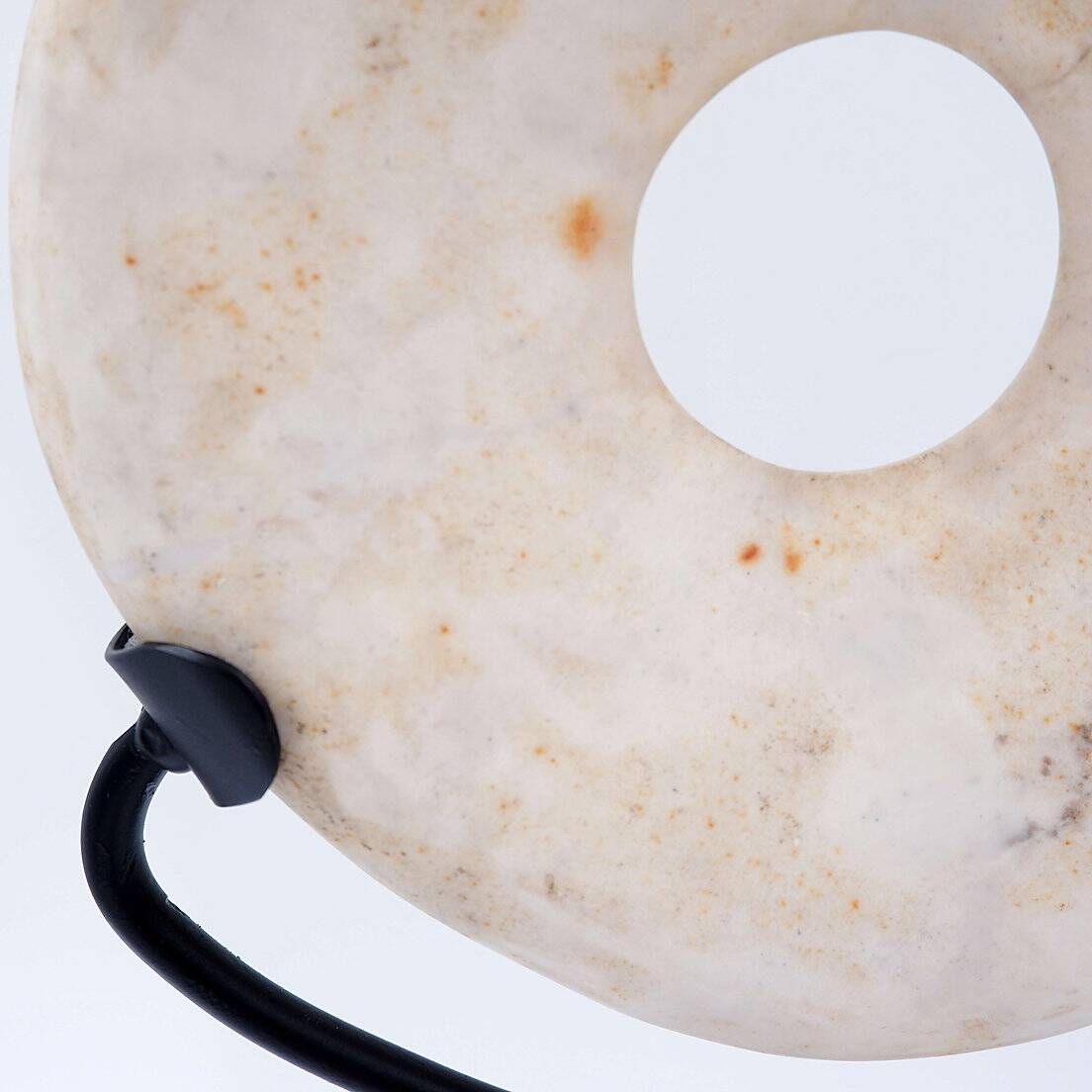 "Wamayuwa" Boiken coin in hand-carved shell mounted on a black metal stand