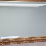 Mirror in gilded stucco wood and beveled glass