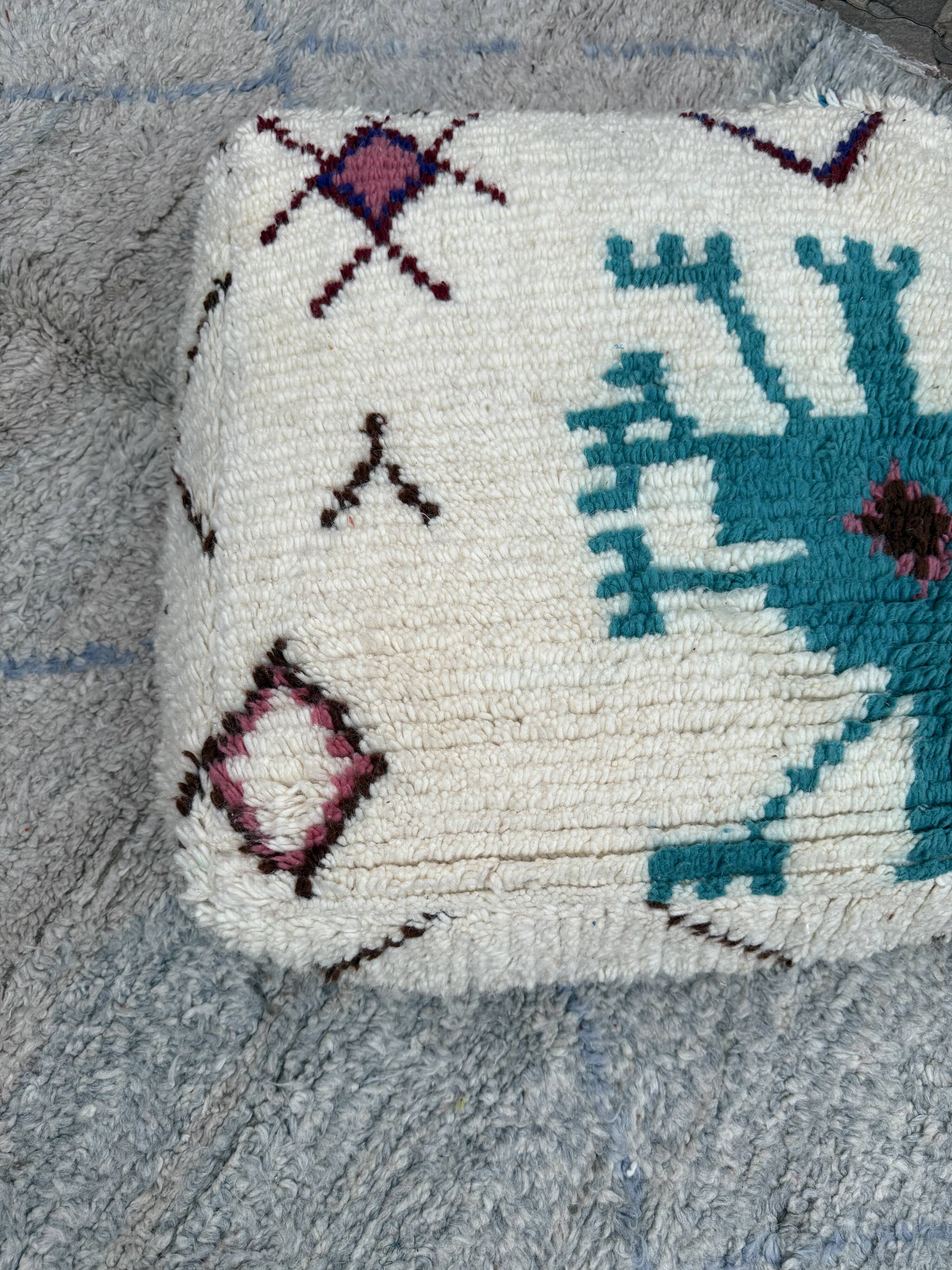 Berber floor pouf: Handwoven Moroccan wool cushion.
