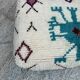 Berber floor pouf: Handwoven Moroccan wool cushion.