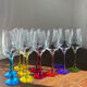 Champagne coupes in glass, multicoloured stems.
