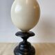 Ostrich egg on blackened wooden base