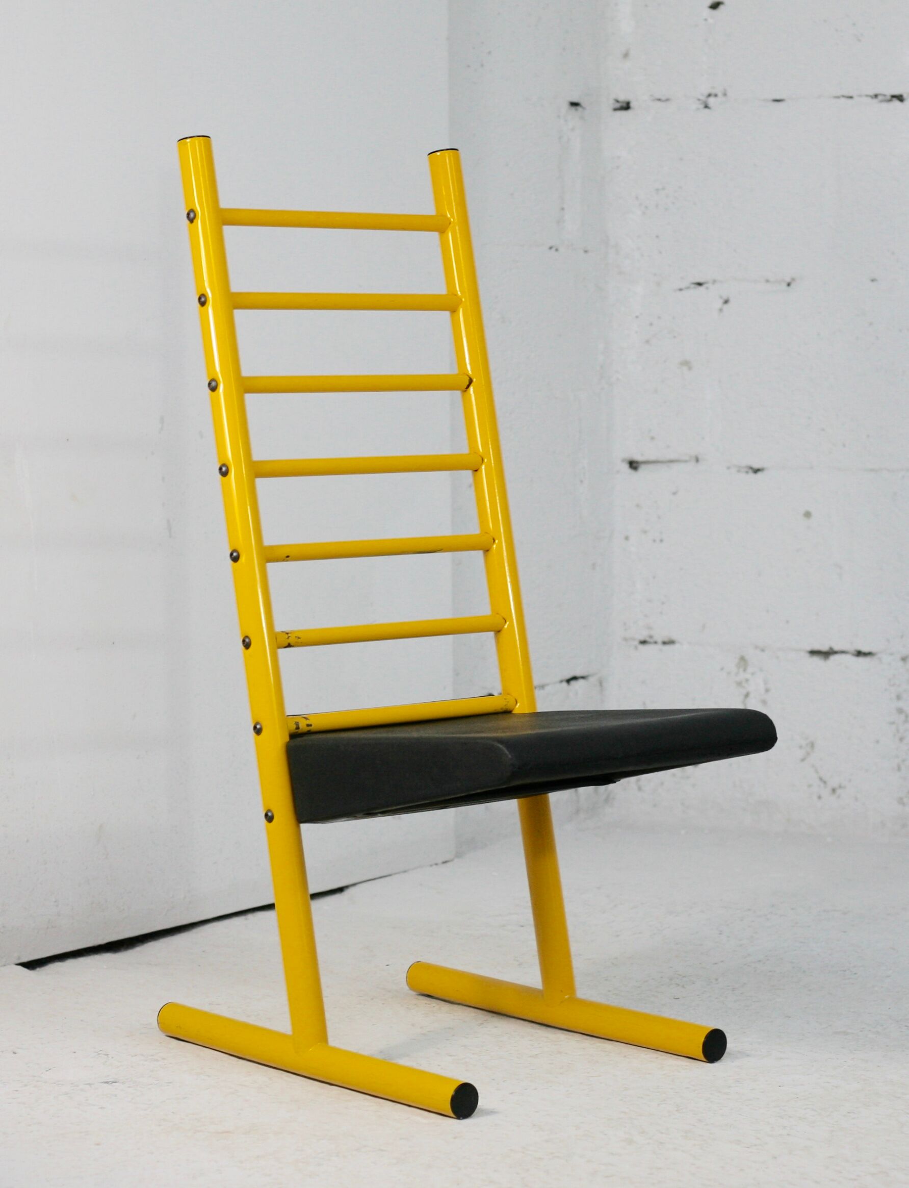 Adjustable seat chair. Circa 1980. Italy. Yellow lacquered steel.