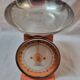 Orange metal household scale from 1970