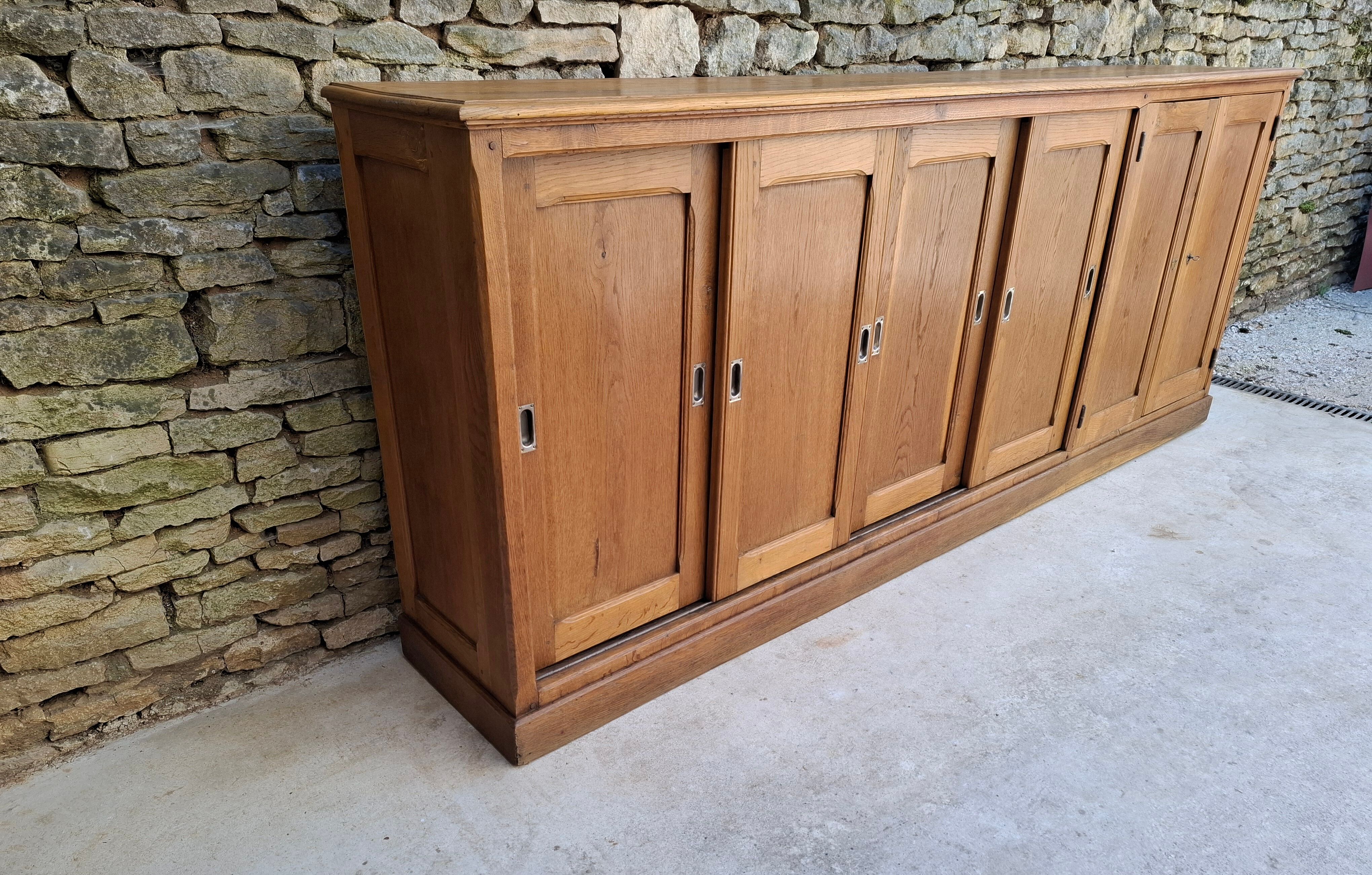 Oak workshop furniture with sliding doors.