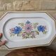 Rectangular earthenware dish with a glazed finish, decorated with a bouquet of flowers.