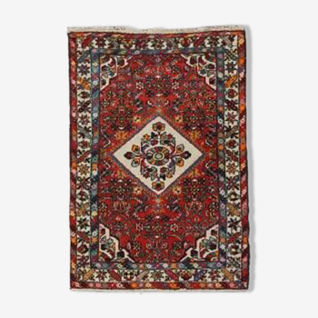 Hand-knotted rug with pompoms and colorful pattern 167 x 106 cm