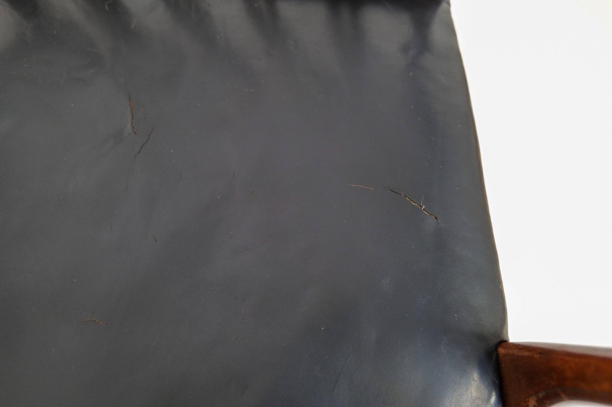 Mid-century armchair by Ole Wanscher for Fritz Hansen, stained beech and leather.