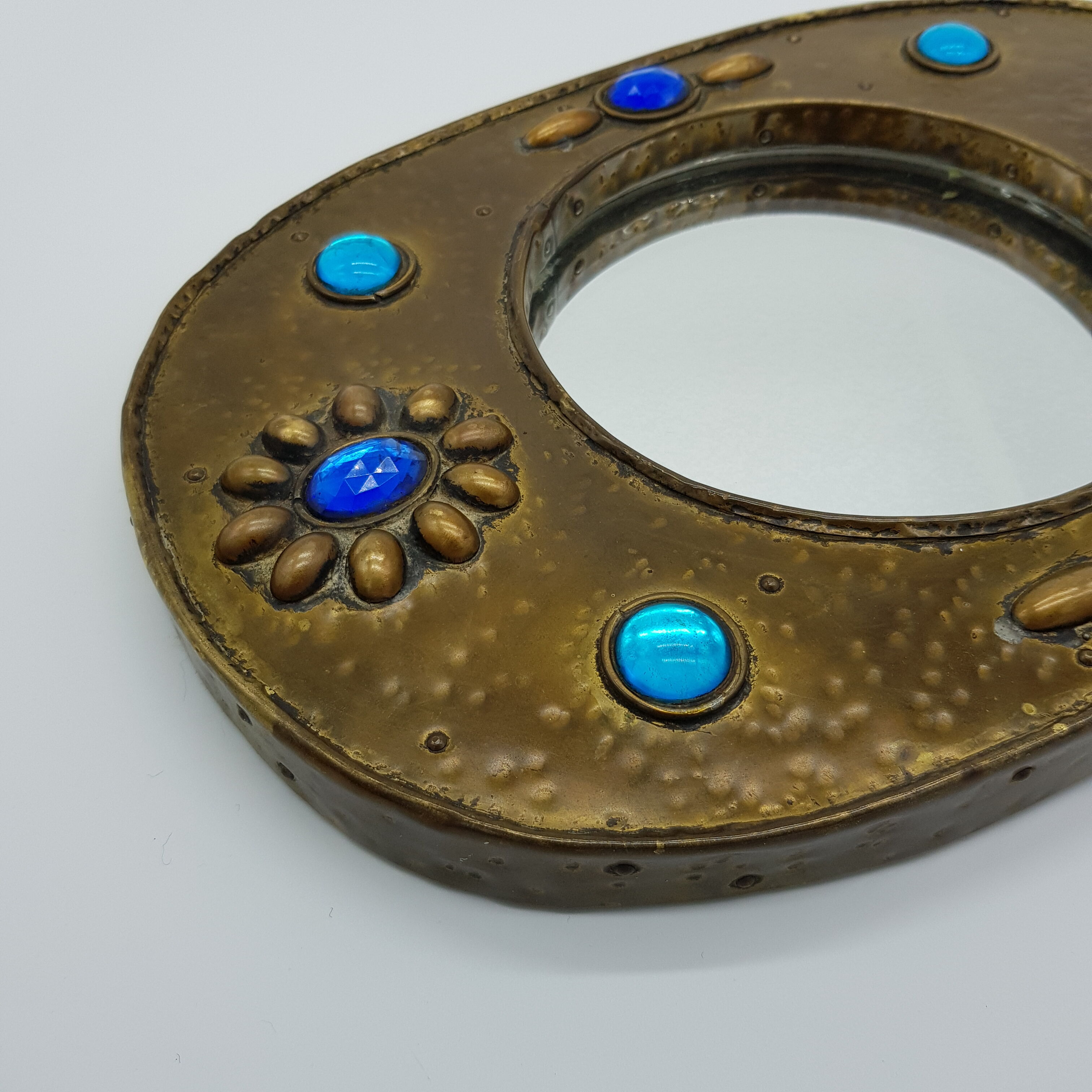 Brass oval mirror and blue cabochons