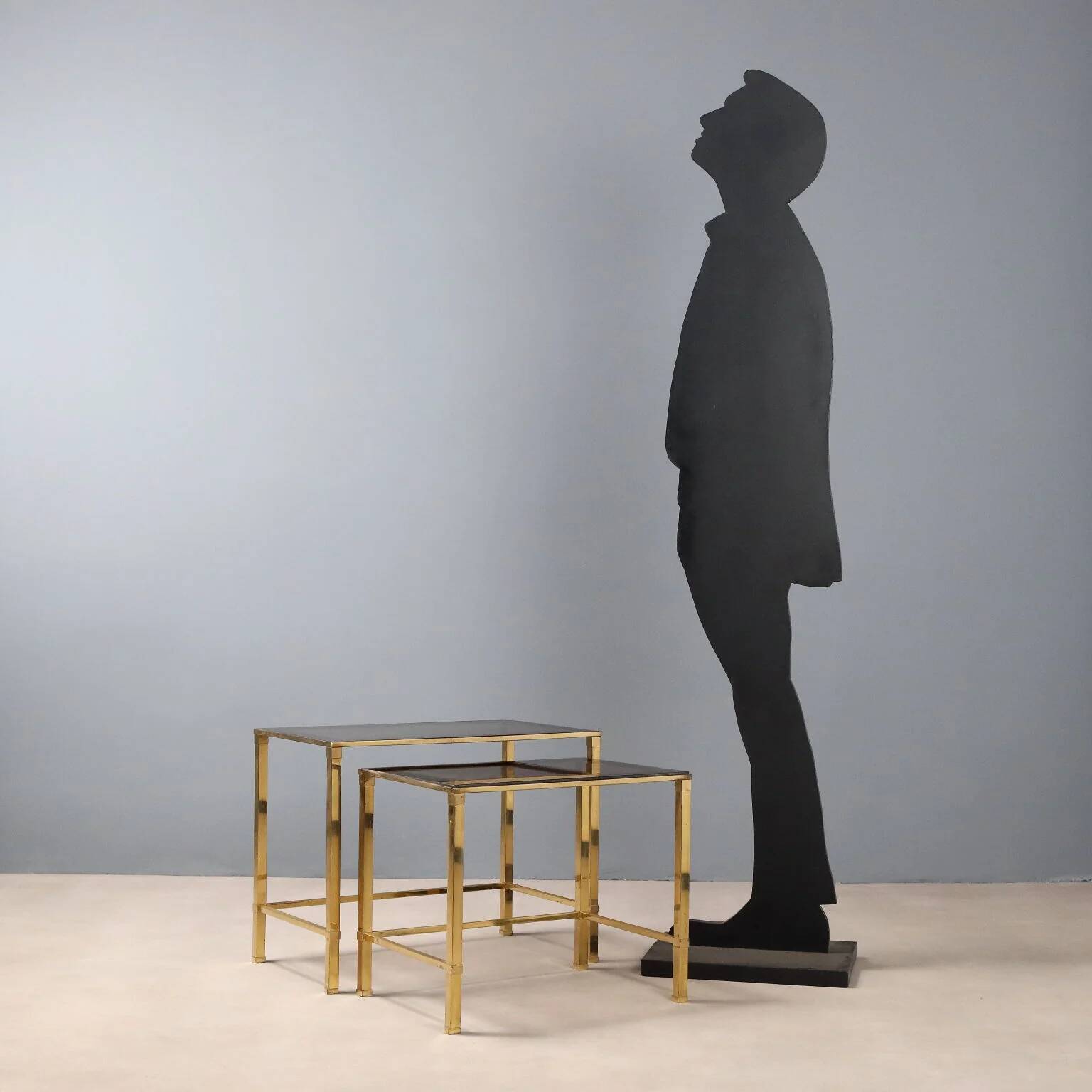 Nested tables in brass and smoked glass.