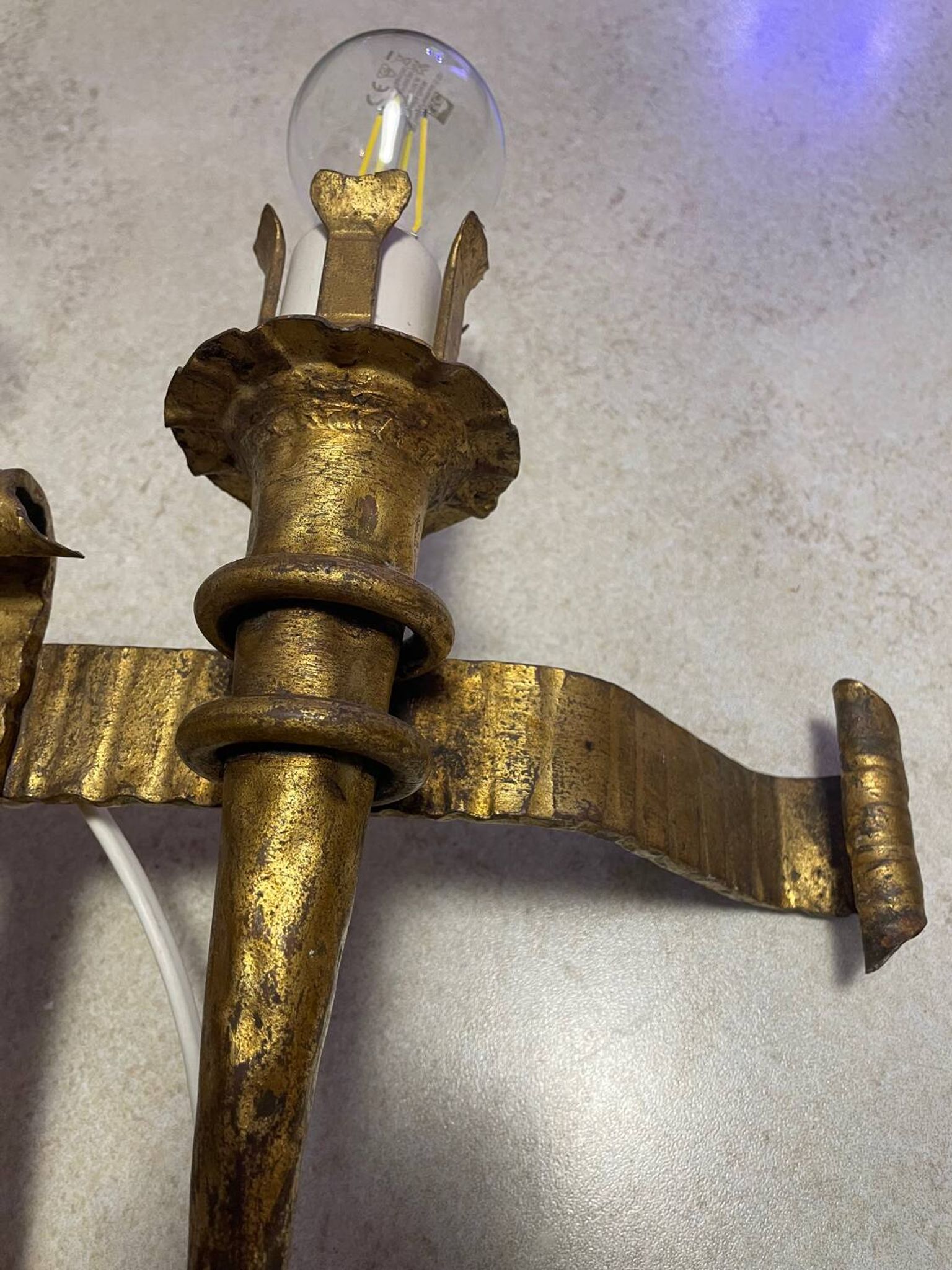 Spanish brutalist wall light in gilded wrought iron.