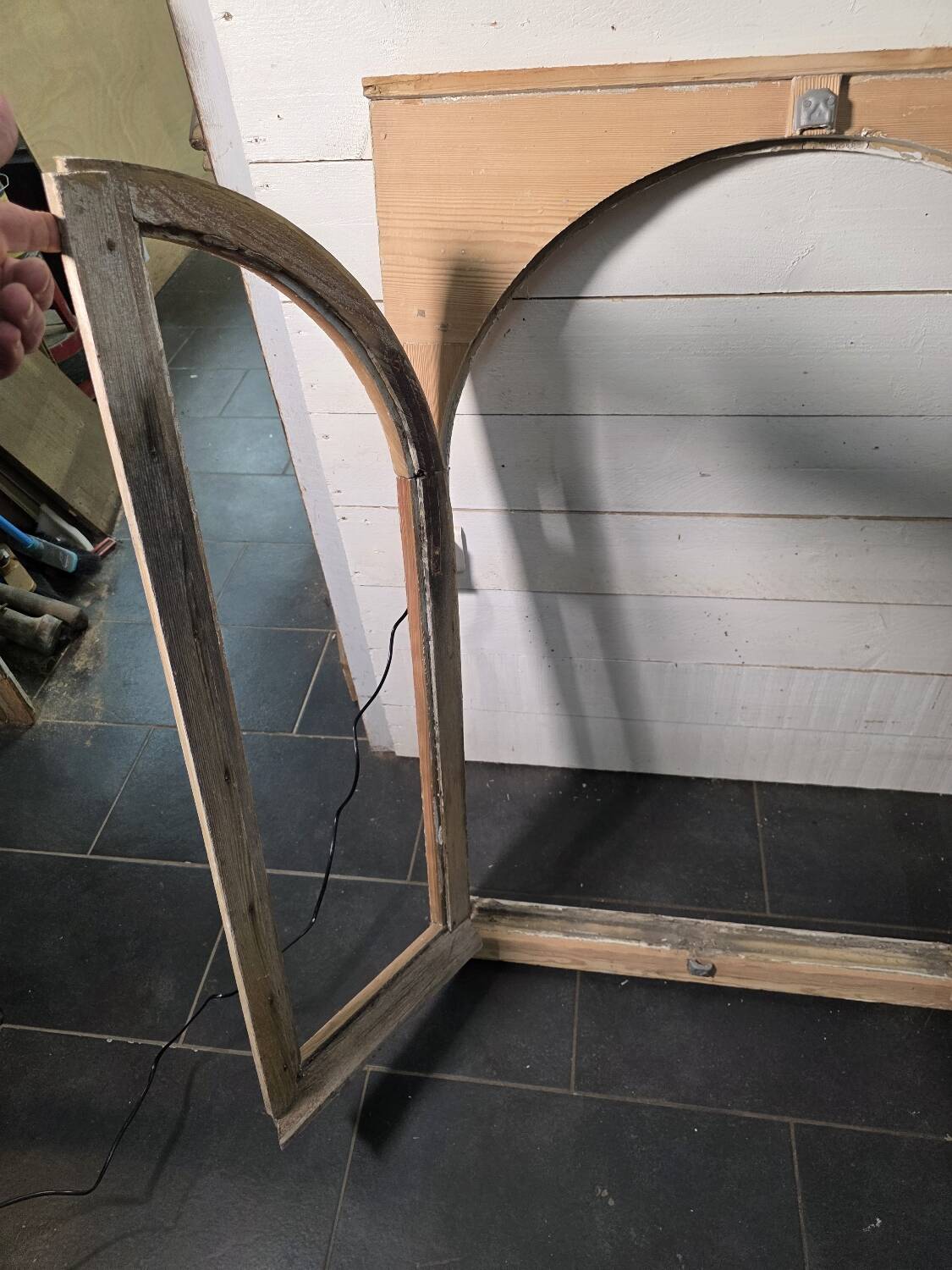 Old arched window made of fir wood