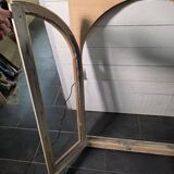 Old arched window made of fir wood