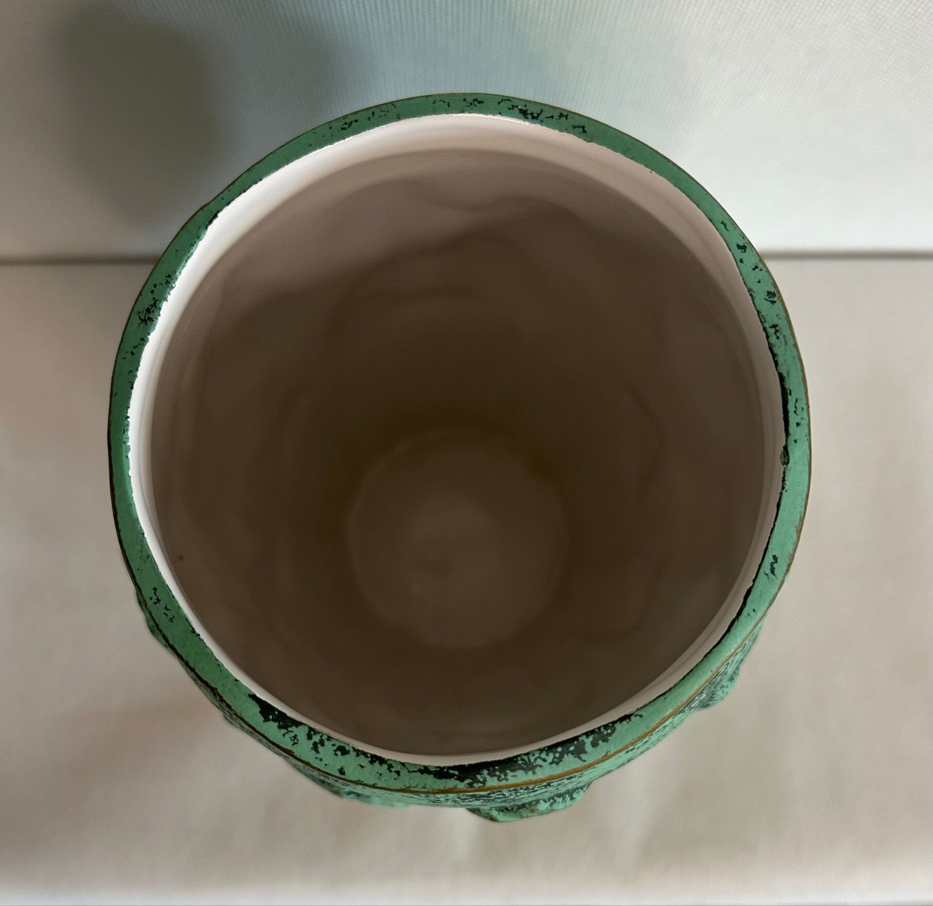 Vintage green patinated ceramic vase with raised floral decoration.