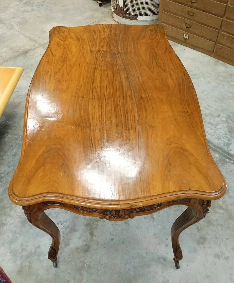 Curved desk in Louis XV style, made of carved and moulded walnut.