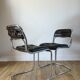 Set consisting of a table in chrome and smoked glass and its 4 tubular chairs in chrome and skaï a