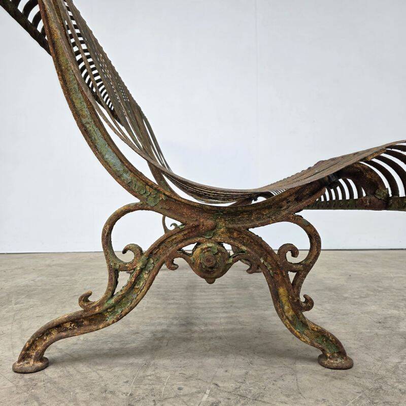 Cast iron garden bench from the late 19th century with slatted backrest.