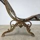 Cast iron garden bench from the late 19th century with slatted backrest.