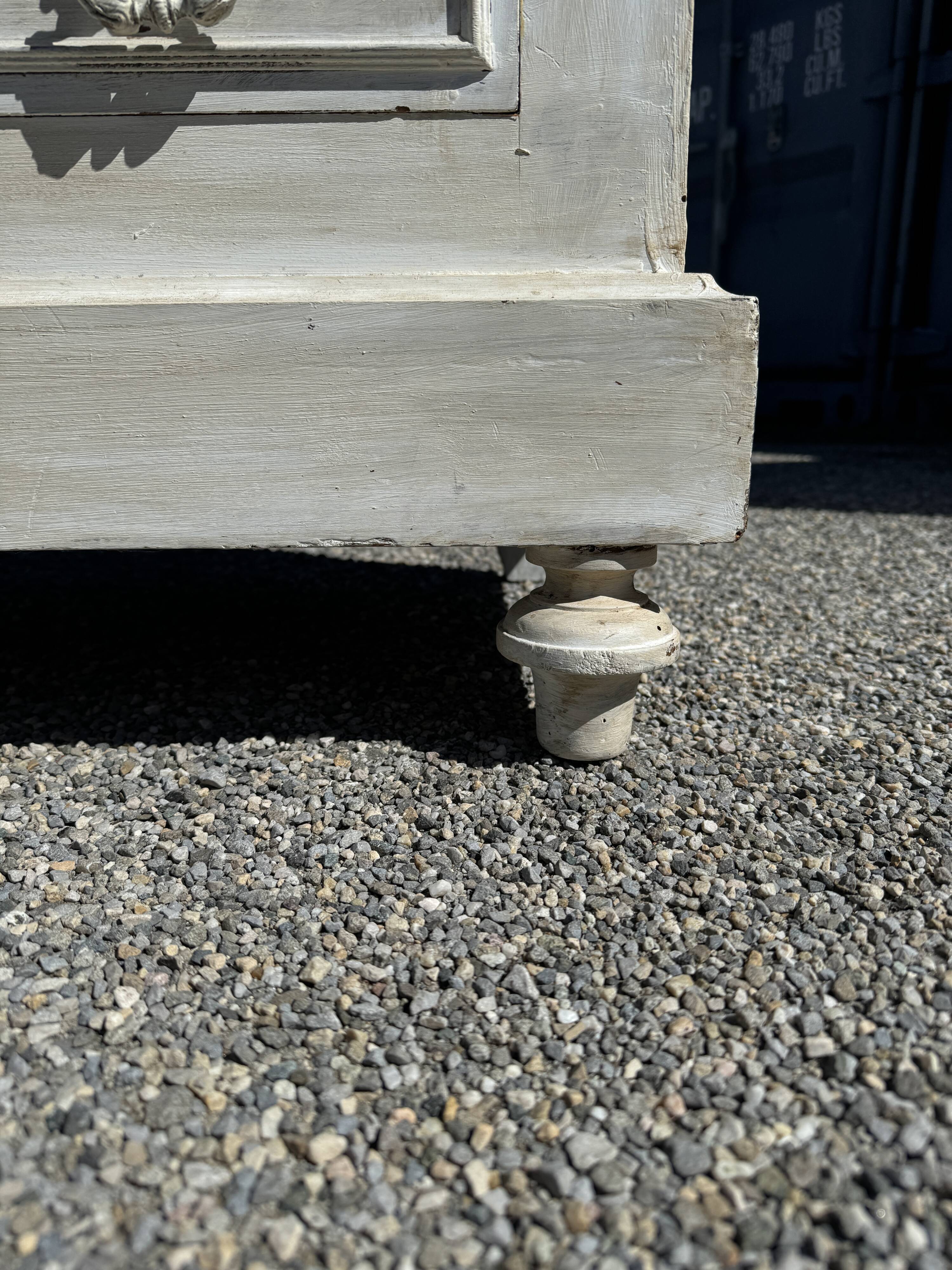 Old chest of drawers in bleached wood with white marble top