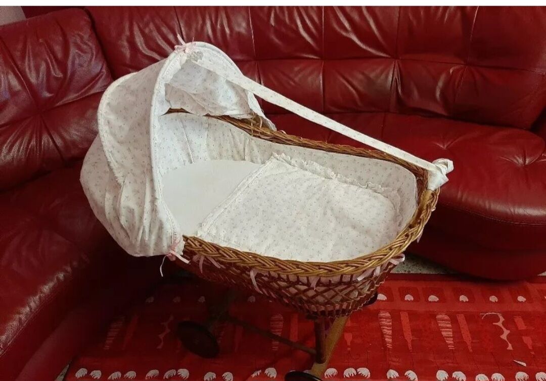 Vintage wicker cradle on wheels from the 1970s.