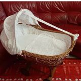 Vintage wicker cradle on wheels from the 1970s.