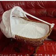 Vintage wicker cradle on wheels from the 1970s.