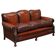 Restored Victorian sofa in leather with claw feet and feather cushions.