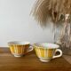 Set of two antique yellow Digoin Sarreguemines cups.