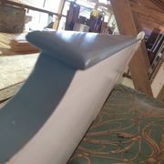 White headboard in Napoleon style with brass feet.