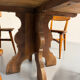 Round table in solid wood, thick top, vintage brutalist style from the 1960s.
