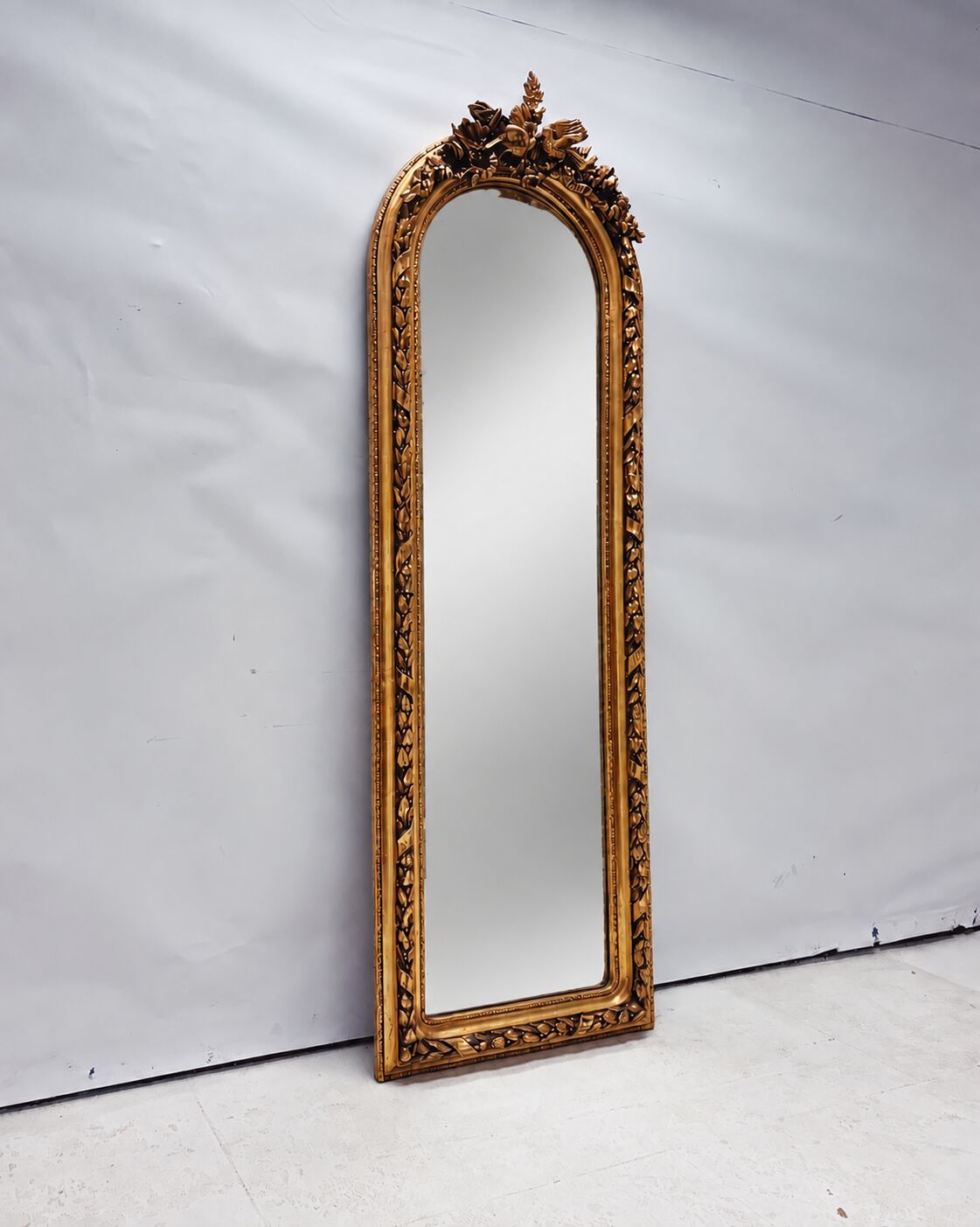Large gold full-length mirror with ornate crest