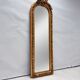 Large gold full-length mirror with ornate crest
