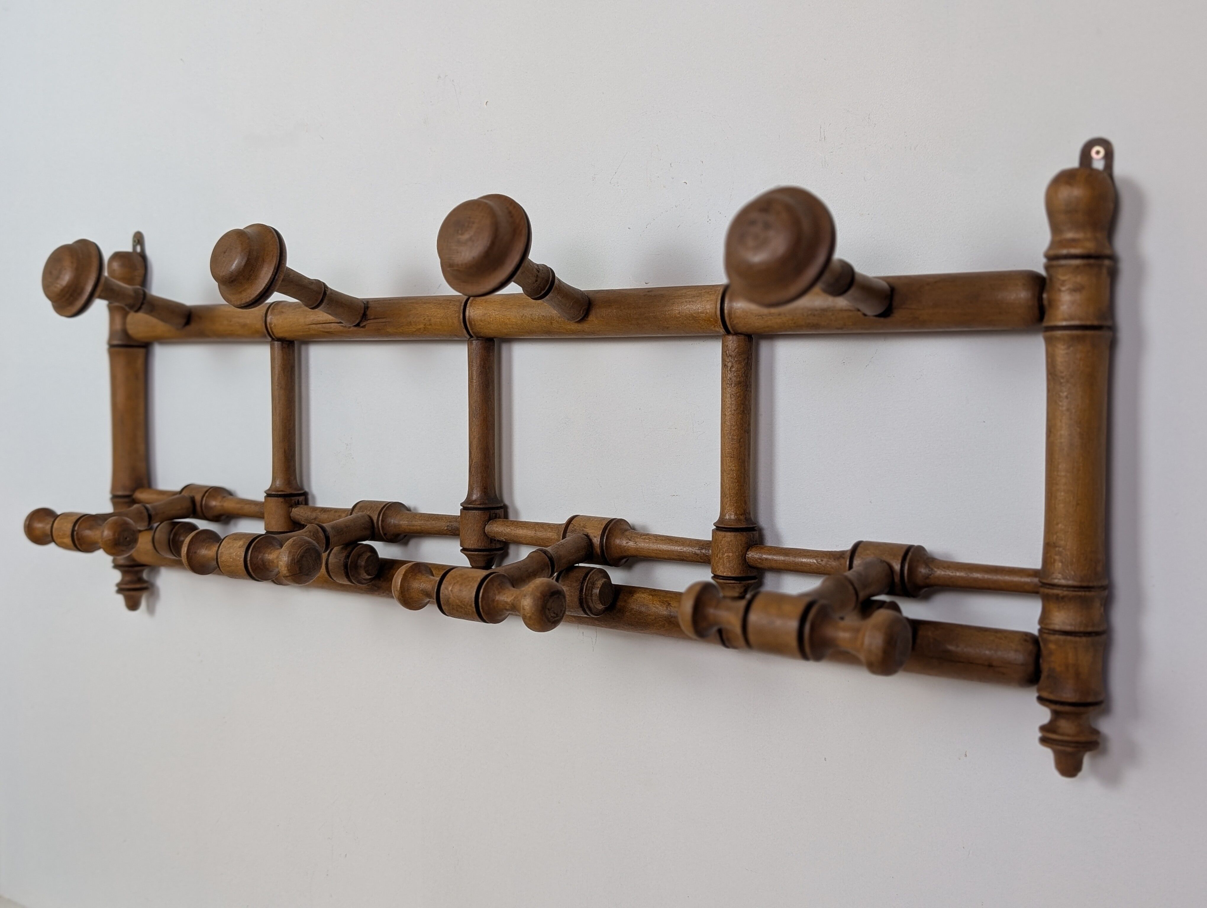 Wall-mounted coat rack made of turned wood