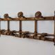 Wall-mounted coat rack made of turned wood
