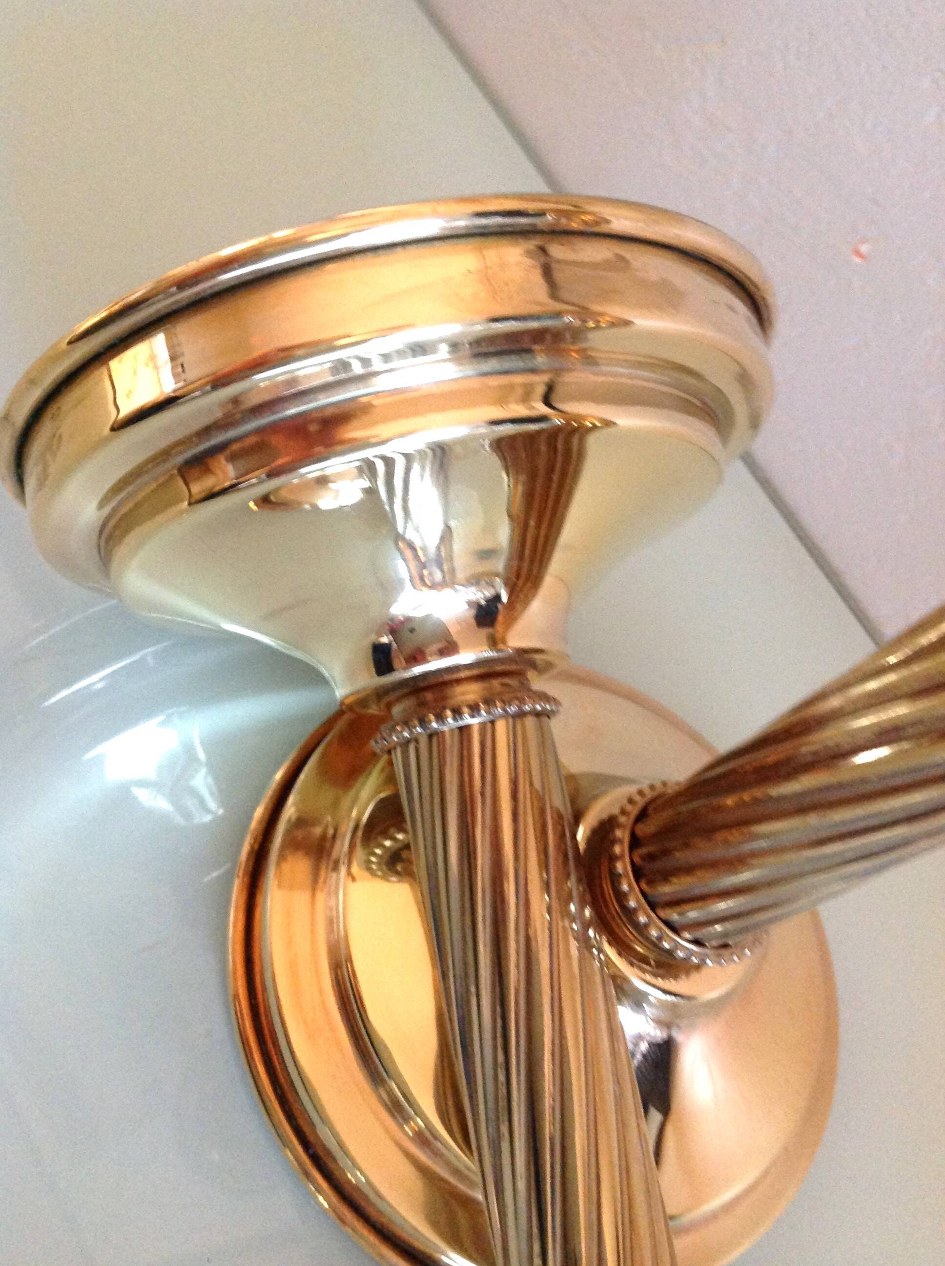 Pair of empire style brass candlesticks