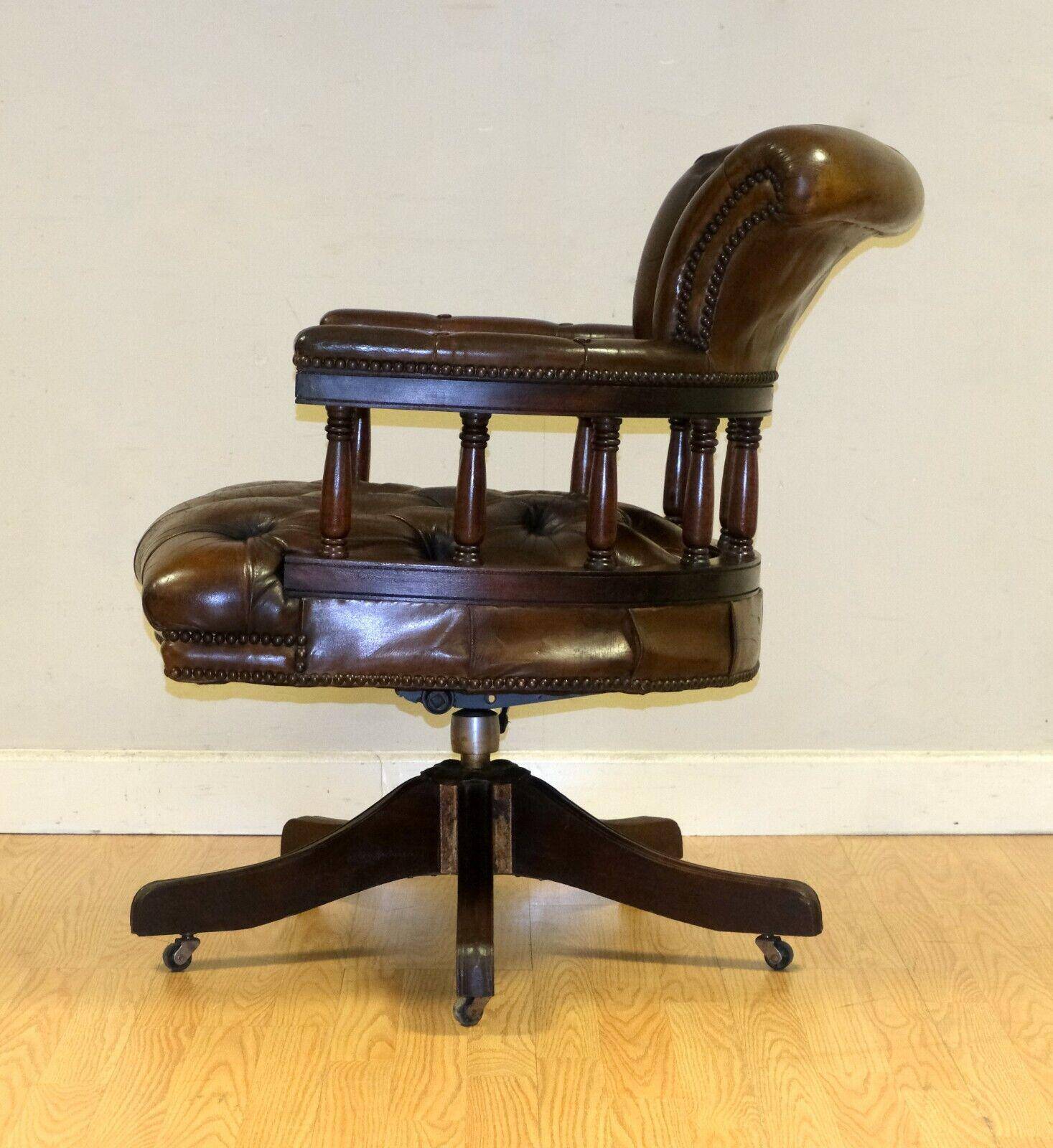 Restored Chesterfield captain's armchair in leather with an oak frame.