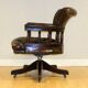 Restored Chesterfield captain's armchair in leather with an oak frame.