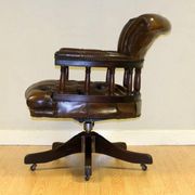 Restored Chesterfield captain's armchair in leather with an oak frame.