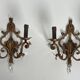 Pair of patinated wrought iron wall sconces with golden acanthus leaves and crystals.
