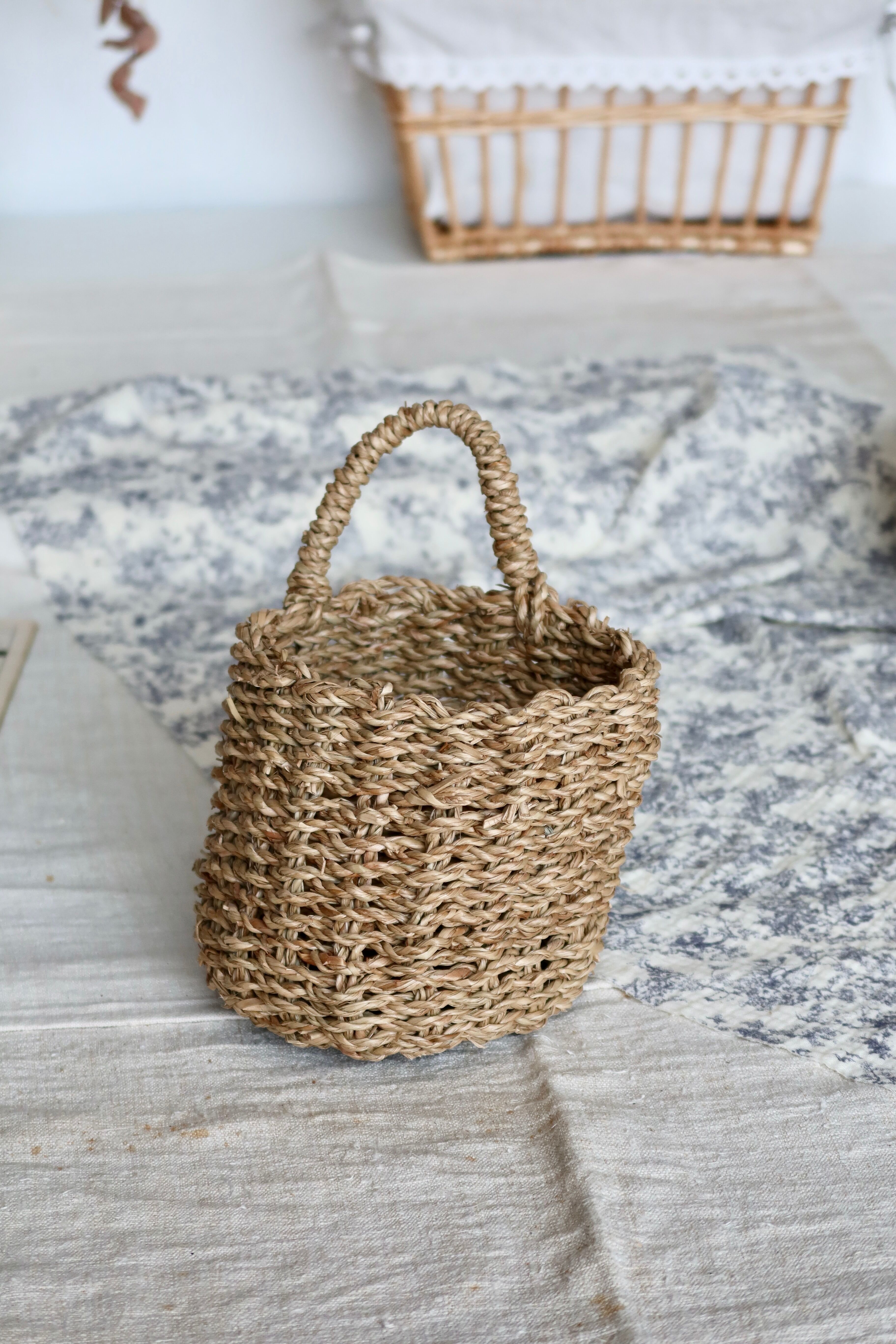 Small vintage woven fiber wall basket with handle