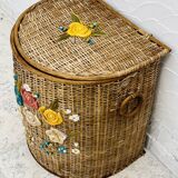 Vintage wicker mannequin with colourful floral decoration.