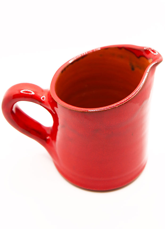 Bright red ceramic pitcher