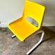 Children's chair in white metal and yellow plastic