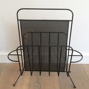 Black lacquered metal and perforated metal magazine rack designed by Mathieu Matégot 50.