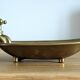 Old soap dish in the shape of a brass bathtub