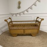Wooden and rattan baby bed