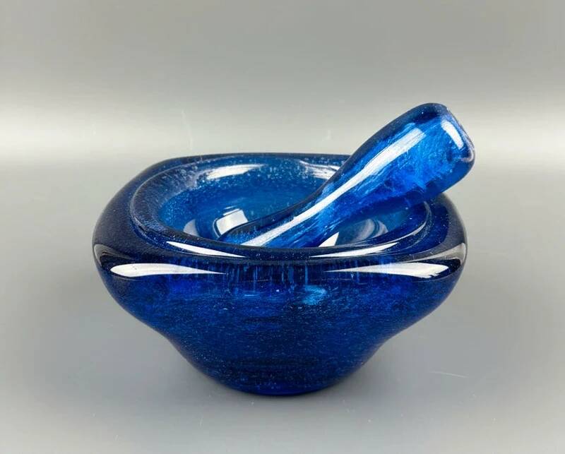 Mortar and pestle in the style of Biot, hard blue.
