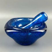 Mortar and pestle in the style of Biot, hard blue.