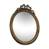 Louis XVI-style oval mirror in gilded stucco circa 1900