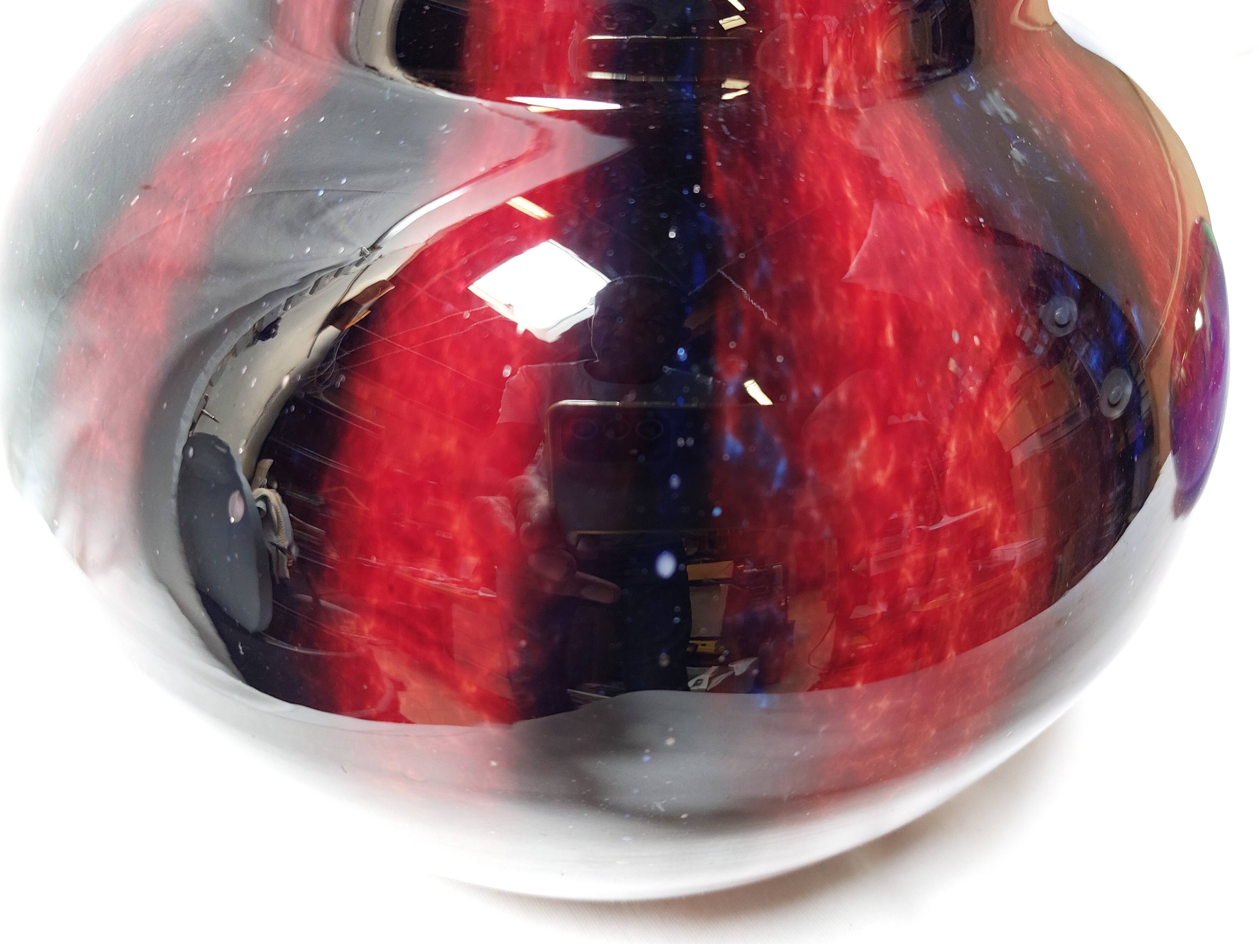 Large vintage blown glass ball vase with red and midnight blue flamed decor